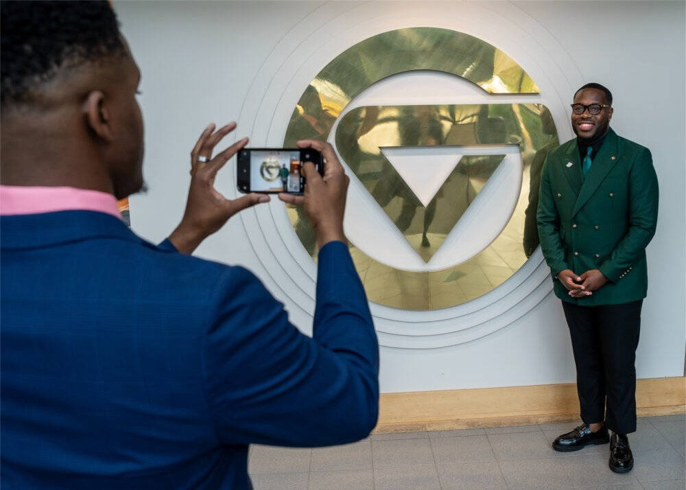 Cleotis Graham takes a photo of Kejuan Stewart inside the Lubbers Student Services Center. The two are from Albany State University.